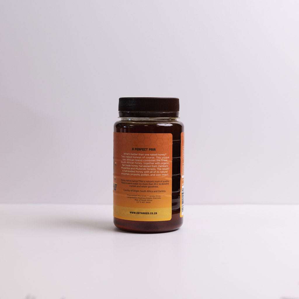 700g jar of Raw Honey African Blend with natural enzymes, pollen, propolis, and wax in clear container with black lid