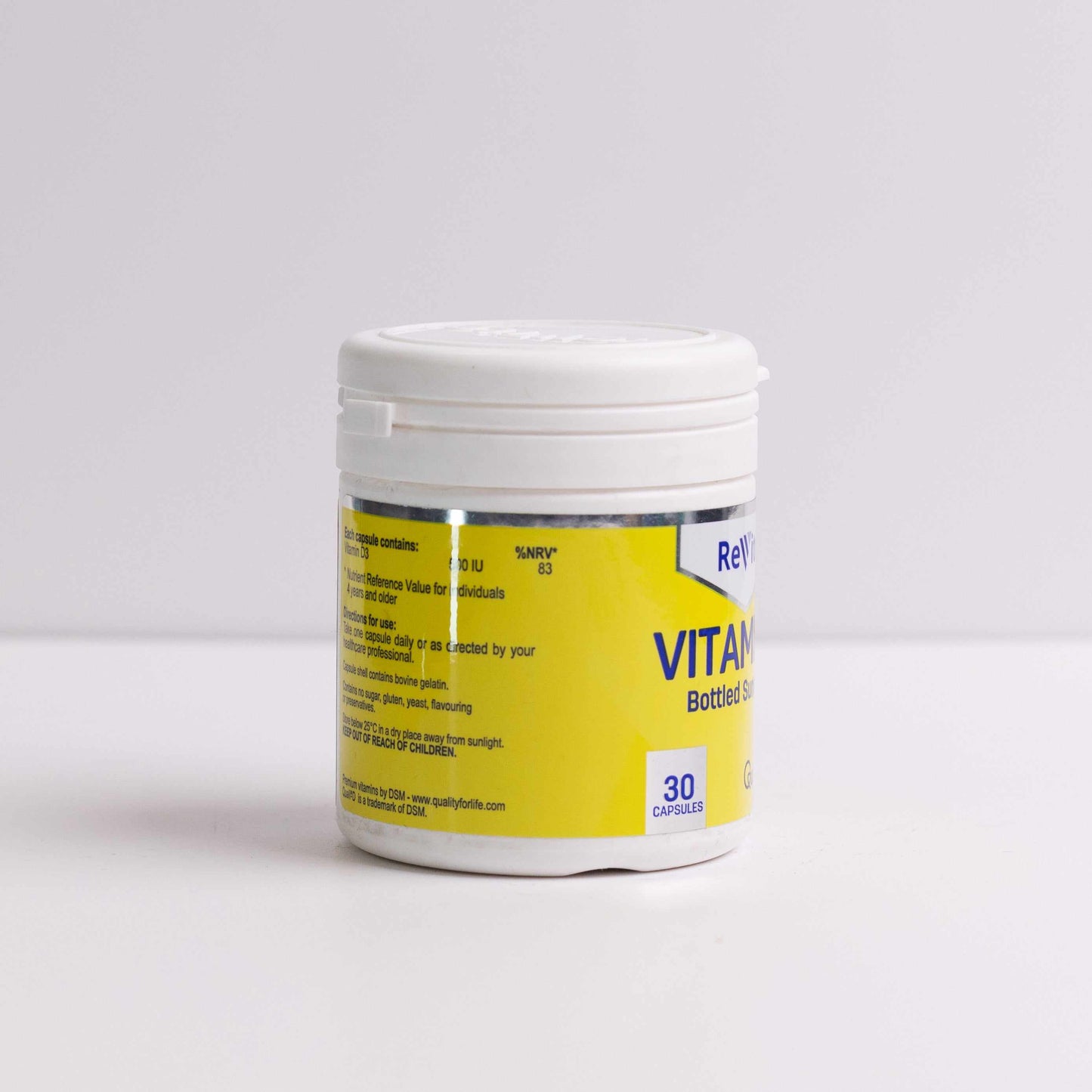 Plastic bottle of vitamin D capsules with yellow label containing 30 capsules for bone and immune health benefits